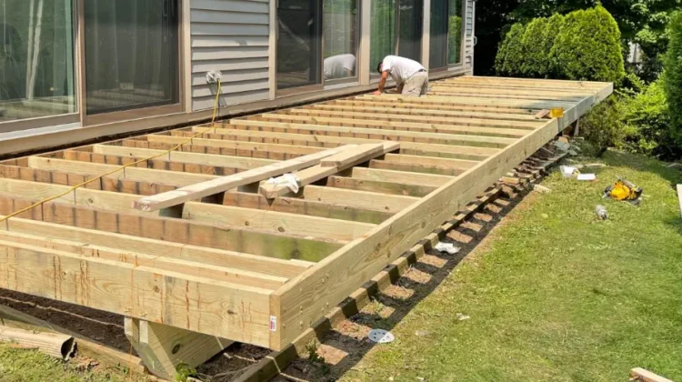 man building a Deck. Friends Home Improvement.
